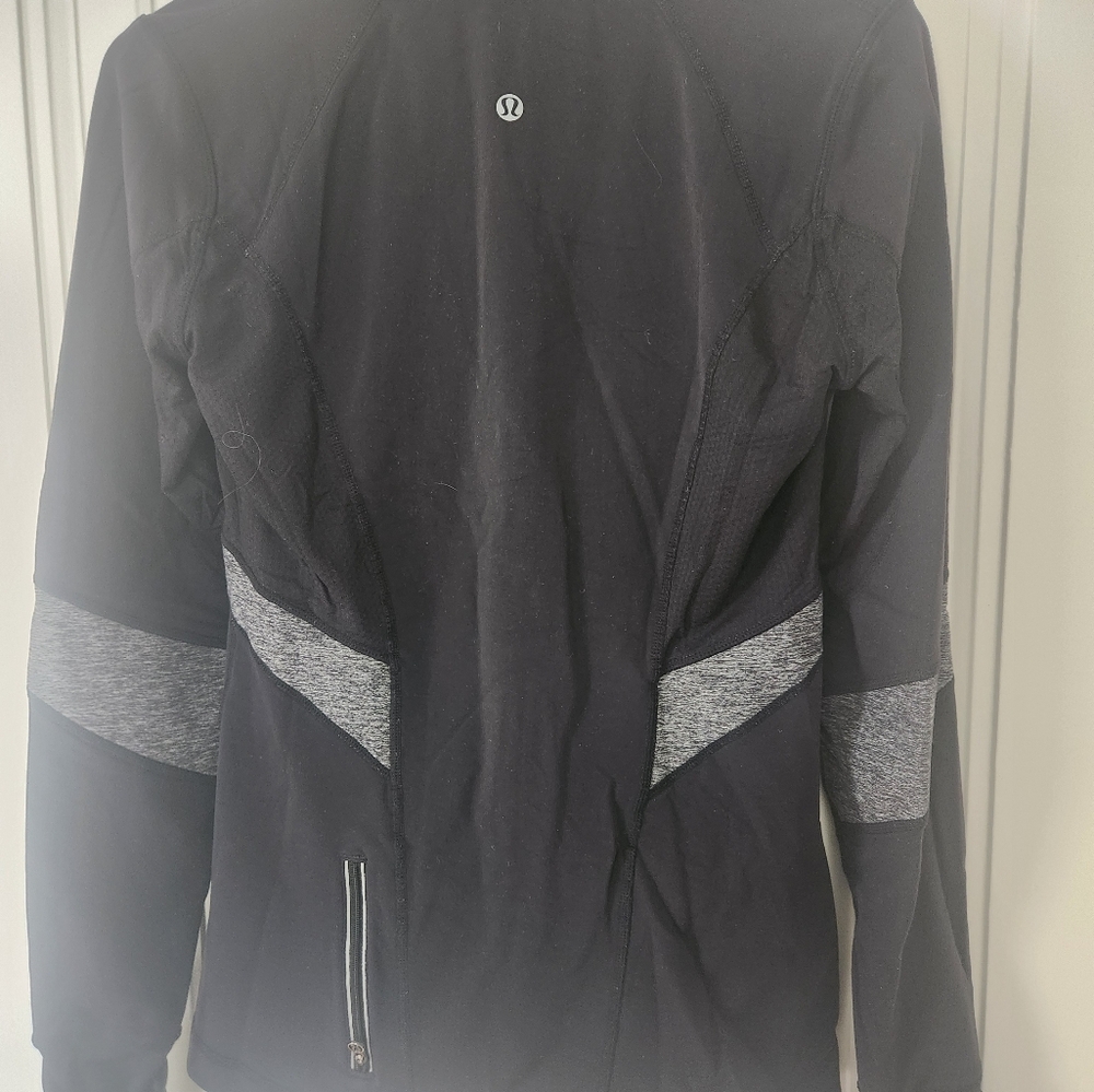 Lululemon 1/4 zip black and grey long sleeve top with thumb holes. Size 6.
